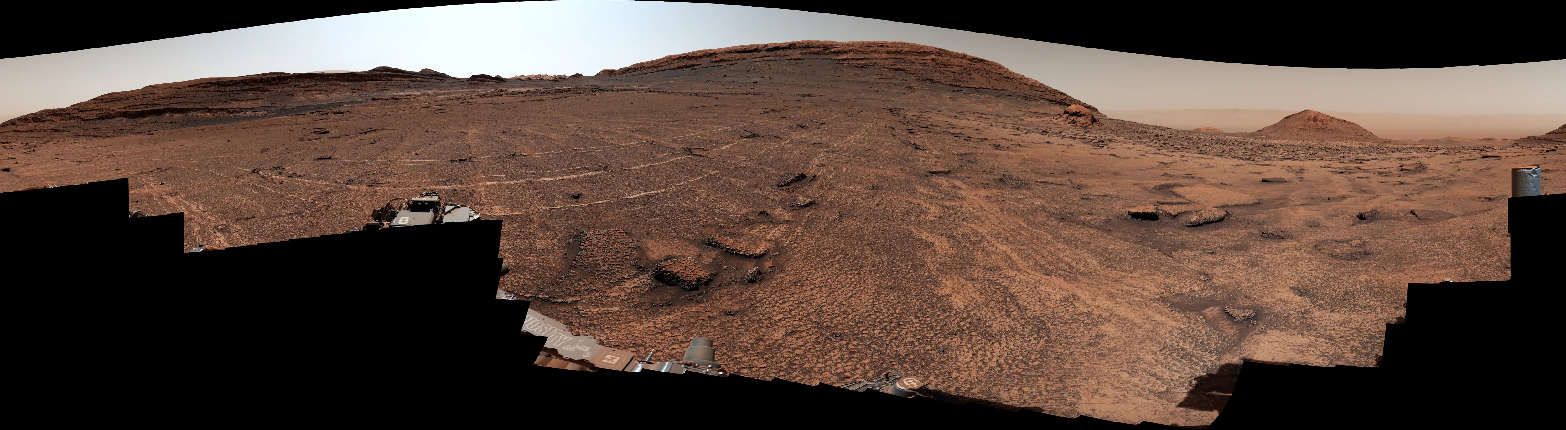 A landscape of Mars's red surface. If you look closely, polygonal structures can be seen on the surface.